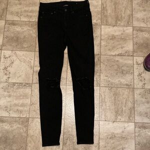 American Eagle black high-rise jeggings/jeans with rips.